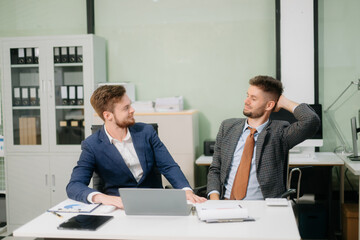 A stressed business team in shock after financial failure. Upset colleagues brainstorm solutions, reacting to bad news