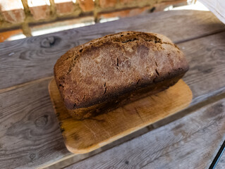 A loaf of bread sitting on top of a wooden cutting board