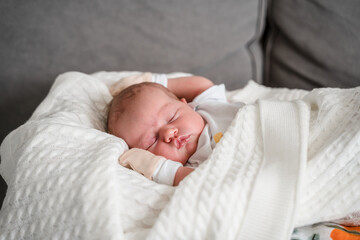 Portrait of a cute newborn baby lying on his back