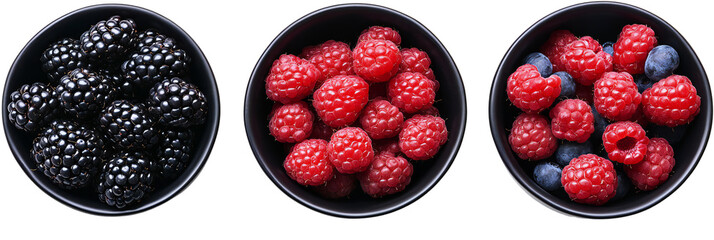 Top view of black bowls filled with fresh berries, isolated on transparent background