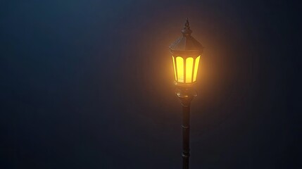 A lone streetlight glowing in the fog on an empty road at night