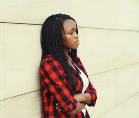 Fashionable young African woman in casual clothing, stylish modern black girl posing in the city