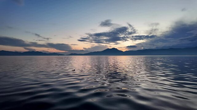 Sunset at Lake Koycegiz panorama, with calm waters reflecting the landscape, Mugla, Turkey. Slow motion video