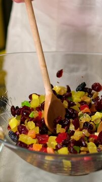 A bowl of dry mix fruit after soaked in rum for making fruit cake. High quality 4k footage