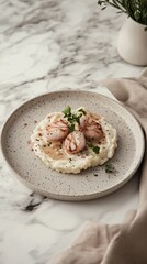 A plate of a smooth mashed potatoes topped with delicate scallops and fresh green herbs, scandinavian style