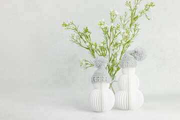 Happy snowmen with spring flowers bouquets. Cute greeting card, Valentine's Day holiday concept