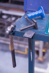 Close up of a set of tools on top of a steel table on a factory