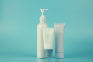 Empty tubes of cream on a blue background. Complex of creams for skin care.