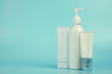 Empty tubes of cream on a blue background. Complex of creams for skin care.
