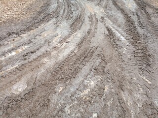 Tire tracks on muddy ground showing patterns and textures  