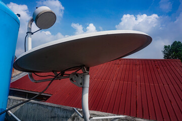 mini parabolic antenna for subscription digital TV broadcasts installed on the roof