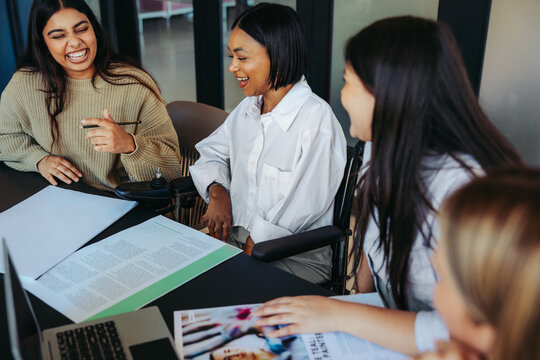 University students engaged in a lively group study session, sharing ideas and laughter in a collaborative learning environment