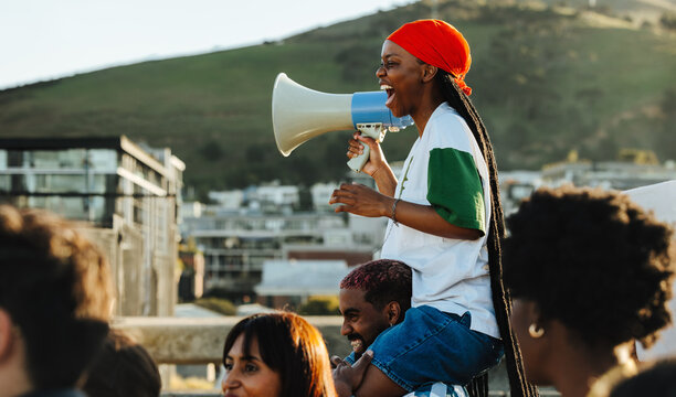 Young protestor with megaphone on a vibrant demonstration day outdoors