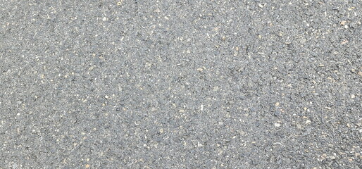 Asphalt road background. Seamless tarmac dark grey grainy road, Asphalt, Street, concrete highway surface. showcasing its detailed texture and fine gravel composition. Pattern with grainy structure,
