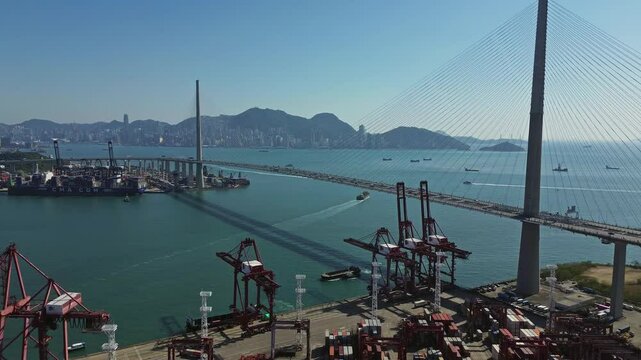 Aerial view of Stonecutters Bridge crossing the bay and the commercial container port in Hong Kong, 4k