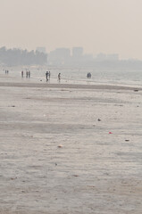 people walking on the Mumbai beach