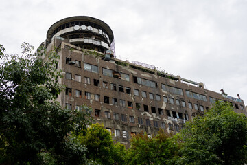 An exterior of the derelict Hotel Continental in Cali, Colombia, with a cloudy sky backdrop.