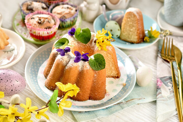 Lemon ring cake with fresh flowers on the top on Easter table