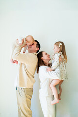Beautiful happy young family with small children resting at home.