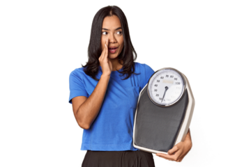 Filipino woman with scale in studio is saying a secret hot braking news and looking aside