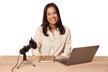 Woman records podcast with laptop happy, smiling and cheerful.