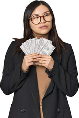 Chinese businesswoman holding dollar bills in studio