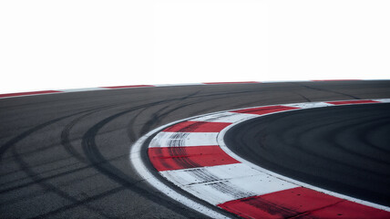 Close-up view of a race track corner with red and white curbs, showing detailed tire marks on the asphalt