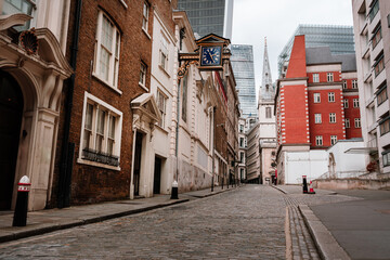 Quiet Cobbled Street In London With Historic Clock