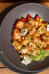 Delicious chicken salad with cherry tomato, feta cheese and letuce