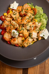 Delicious chicken salad with cherry tomato, feta cheese and letuce