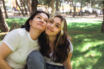 Smiling women enjoying a sunny day in the park surrounded by nature © Alina