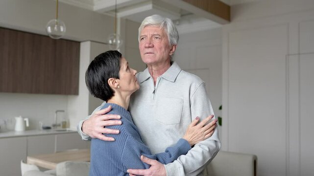 Sad almost crying distressed woman embracing hugging husband with love, offering comfort. Cancer diagnosis, relationship crisis, supporting confused husband, comforting each other through tough times
