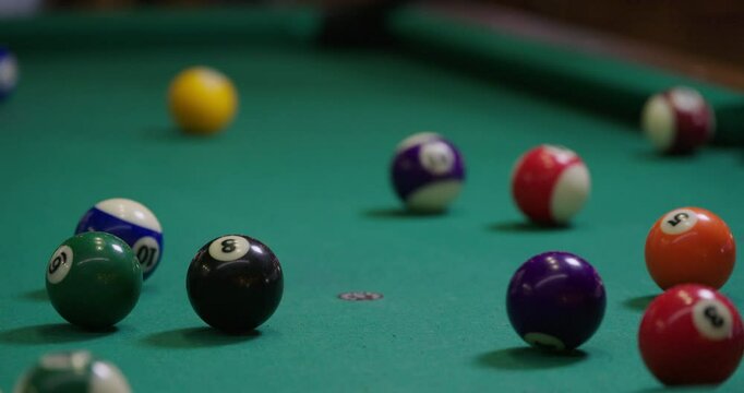 billiard balls getting an opening break on a table