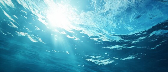 Obraz premium A beautiful blue ocean with a bright sun shining through the water