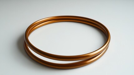 Elegant bronze rings on a clean white surface creating a modern aesthetic perfect for jewelry design or abstract art projects showcasing simplicity