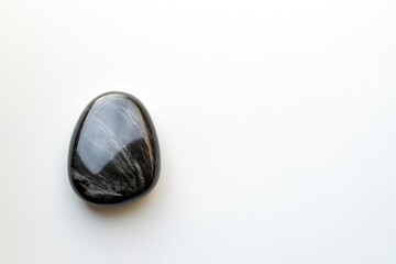 Naklejka premium capture polished river stone placed on white background circumventing any shadows with generous copy space around it