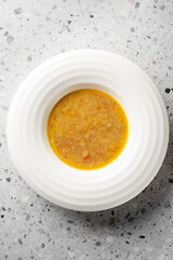 A close-up view of a warm, hearty soup served in a white bowl, featuring a rich texture and inviting color, perfect for food photography and culinary presentations.