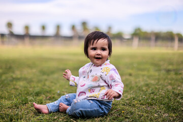 Little girl playing with bubbles in garden, nice day and funny