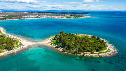 Aerial drone view of the beautiful Park šuma Kašteja (Kasteja), a lush green oasis on a peninsula near Medulin, Croatia. Surrounded by crystal-clear Adriatic waters