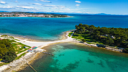 Aerial drone view of the beautiful Park šuma Kašteja (Kasteja), a lush green oasis on a peninsula near Medulin, Croatia. Surrounded by crystal-clear Adriatic waters