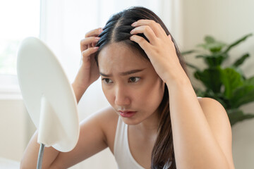 Young woman scratching her head feeling itch from dermatology problem