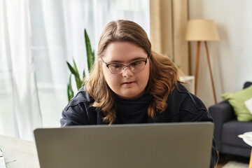 Young woman with Down syndrome engages in online activities at home in cozy surroundings