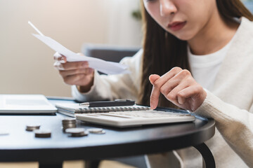 Close-up person using a calculator to  plan monthly expense and account