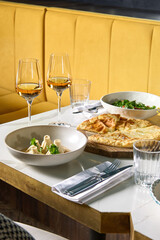 Dinner at the restaurant, chef's dishes and glasses of wine. Romantic dinner.