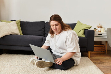 Young woman with Down syndrome enjoys a cozy afternoon at home while using her laptop