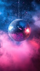 Obraz premium Shimmering disco ball suspended in a vibrant haze of pink and blue light casting a nostalgic glow and festive atmosphere