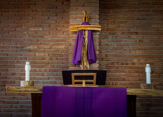 A sermon book and cross draped in purple for observance of Lent
