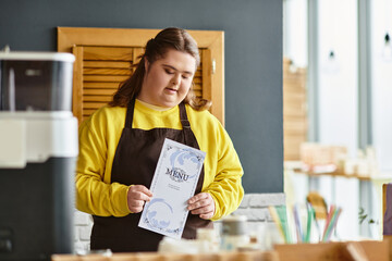 Young woman with Down syndrome confidently showcasing the menu in a cozy cafe setting