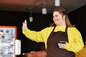 Young woman with Down syndrome engages with customers in vibrant cafe setting
