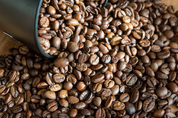Box with coffe on the roasted coffe beans.